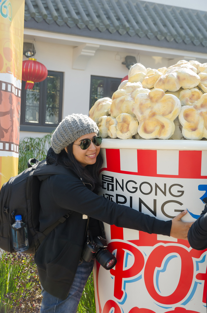 Being a big kid, hugging this giant bucket of popcorn!