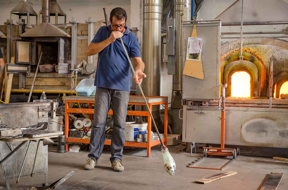 Blowing the glass into shape