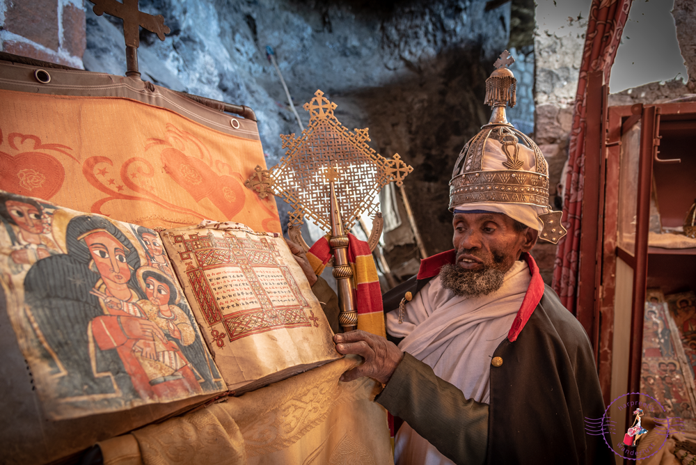 Amharic Priest and Ancient Bible at ToNeakutoleab Monastery